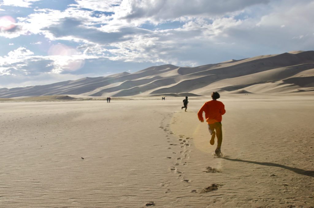 Running across the sand flats at Great Sand Dunes