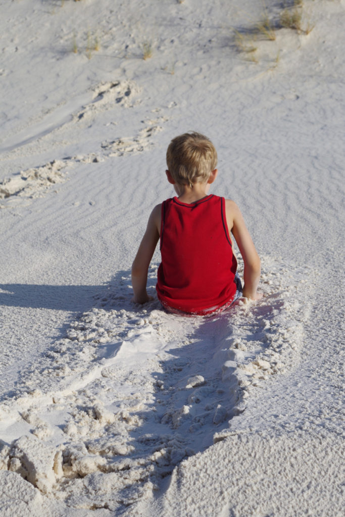 Sliding down the dunes at White Sands